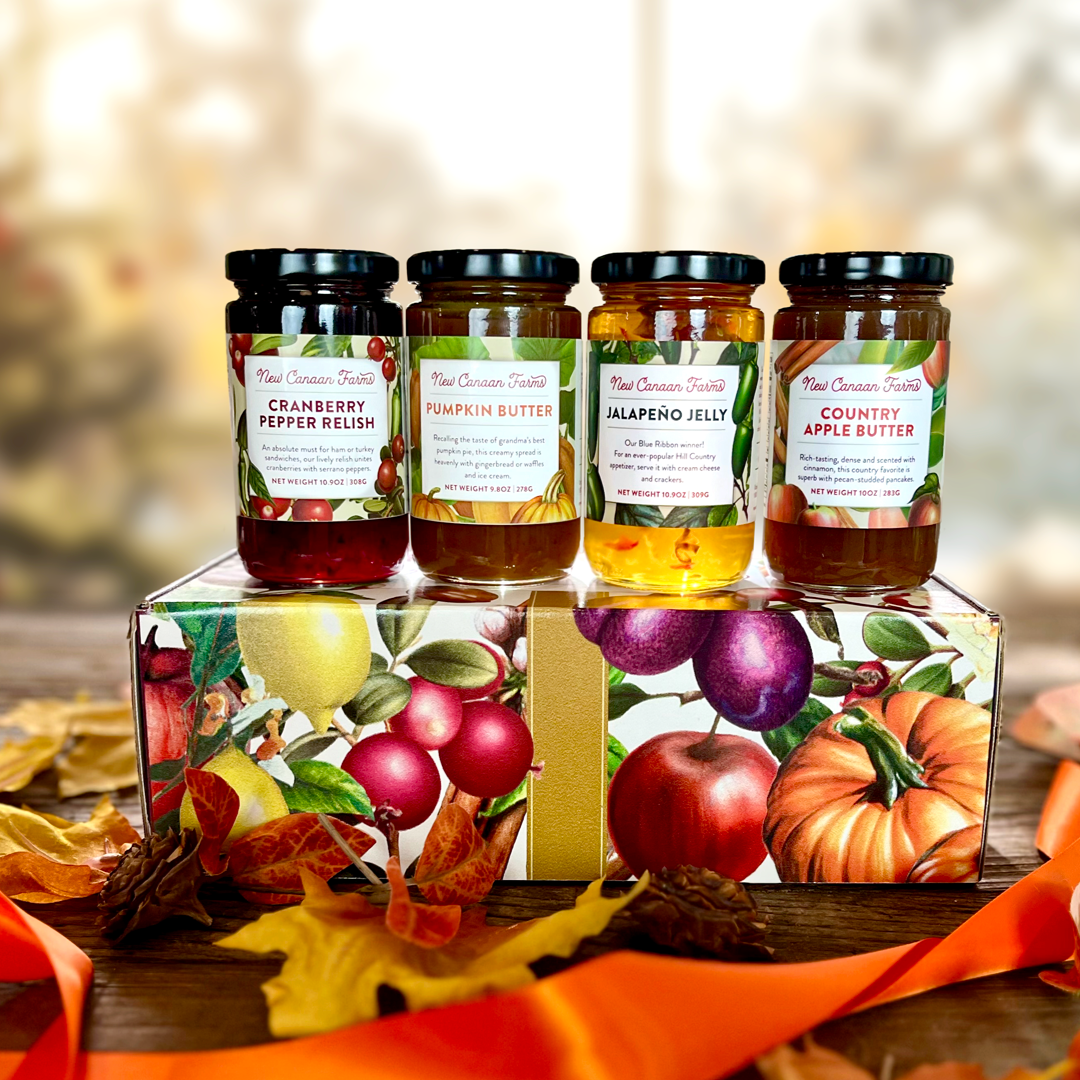 Set of jars with labels on a decorative stand with autumn-themed design