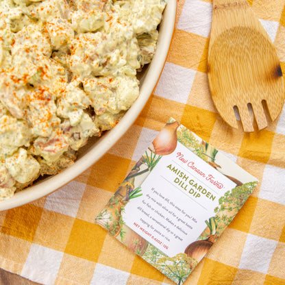 Amish Garden Dill Dip package with a wooden spoon on a checkered tablecloth