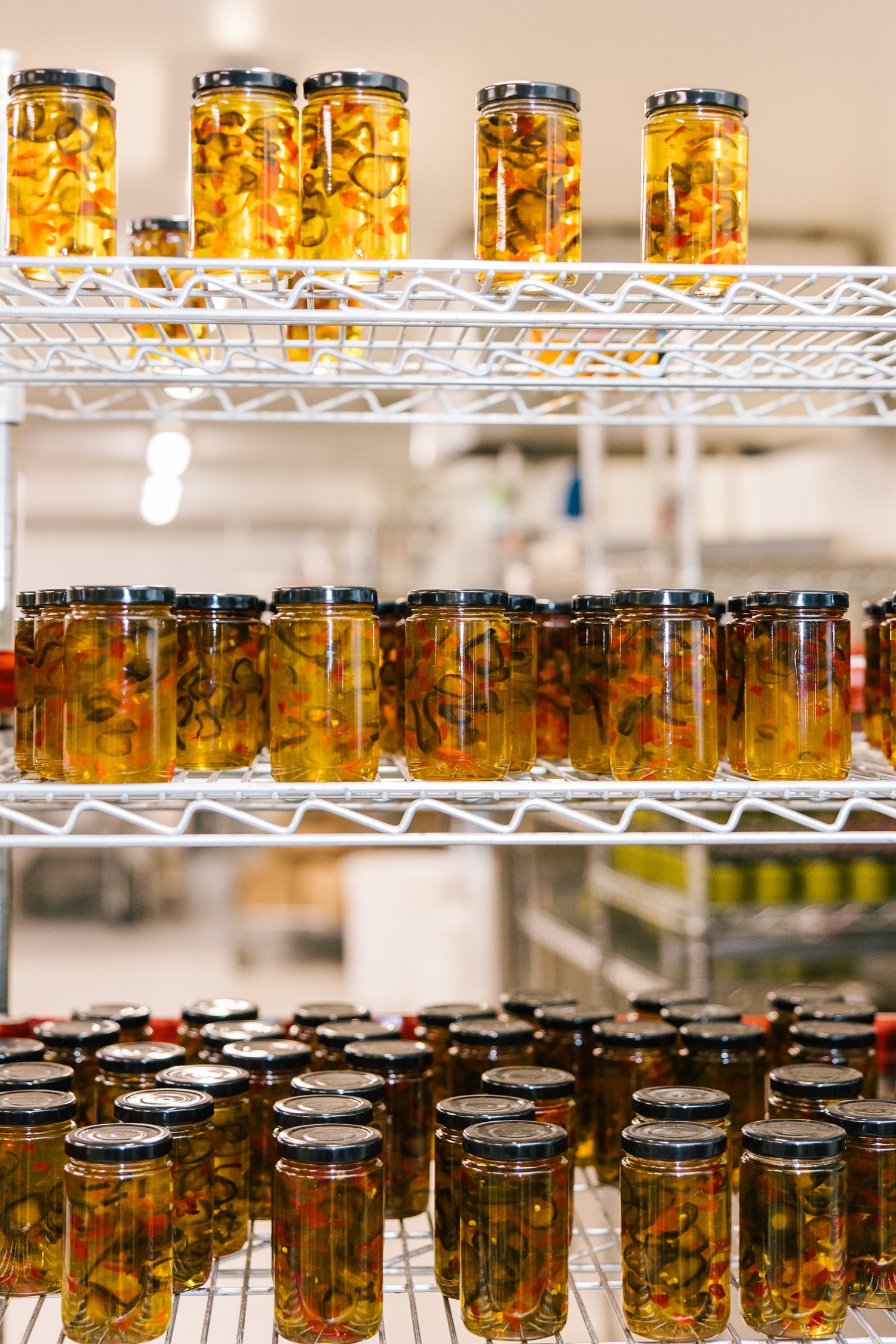 Shelves filled with jars of pickled vegetables in production