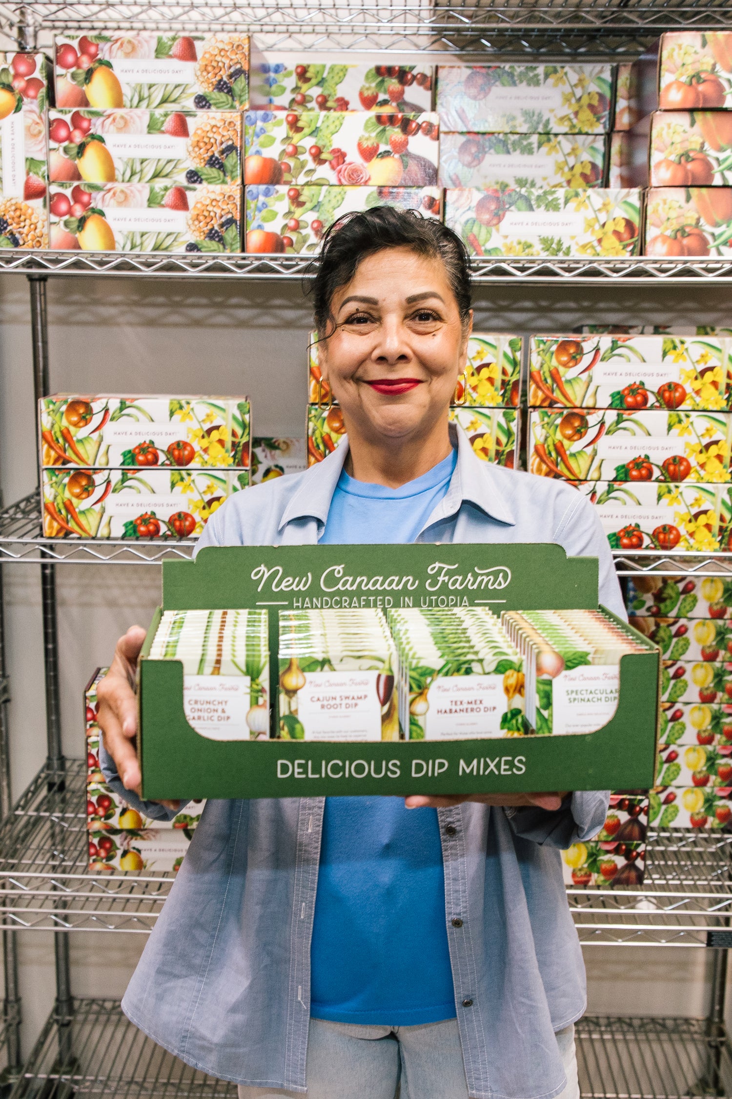 Employee holding box of dip mixes