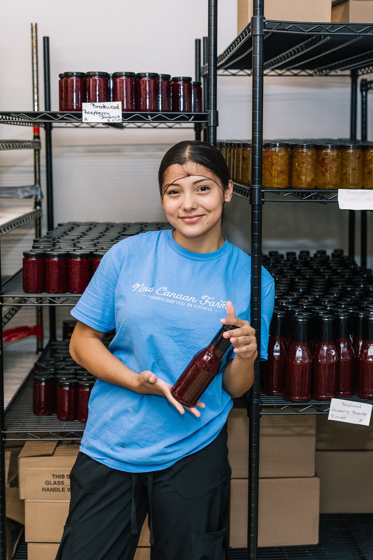 Team member holding sauce in production