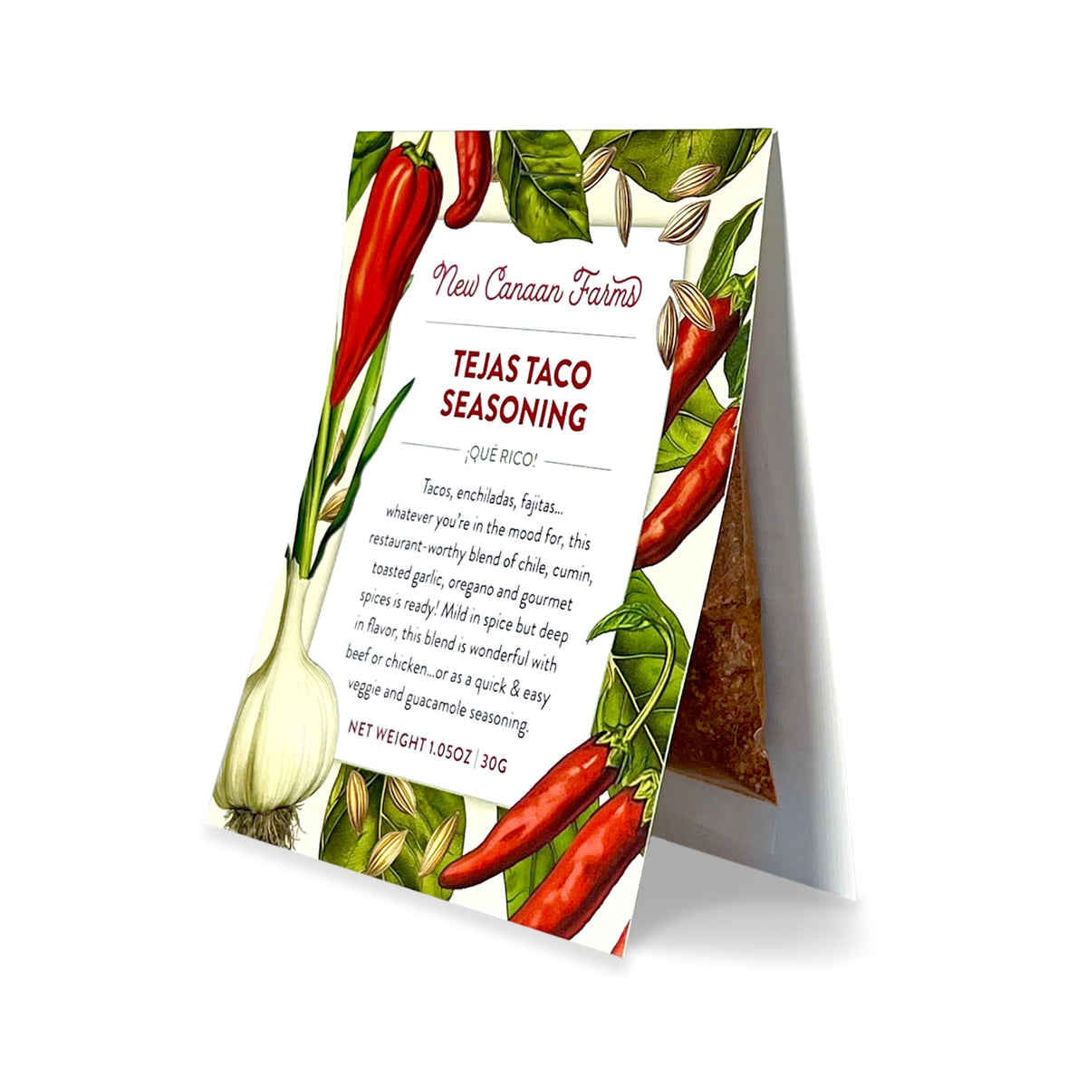 A packet of New Canaan Farms Tejas Taco Seasoning standing upright with red chiles and garlic on the label