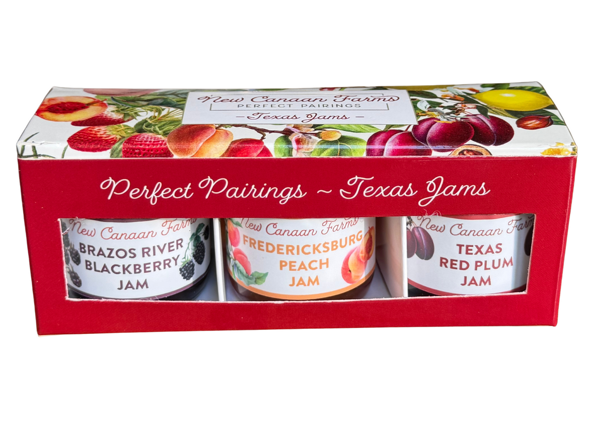 Three jars of Texas jams in a decorative box with fruit illustrations on a white background.
