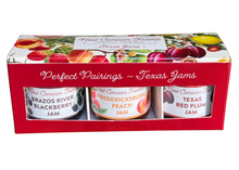 Three jars of Texas jams in a decorative box with fruit illustrations on a white background.