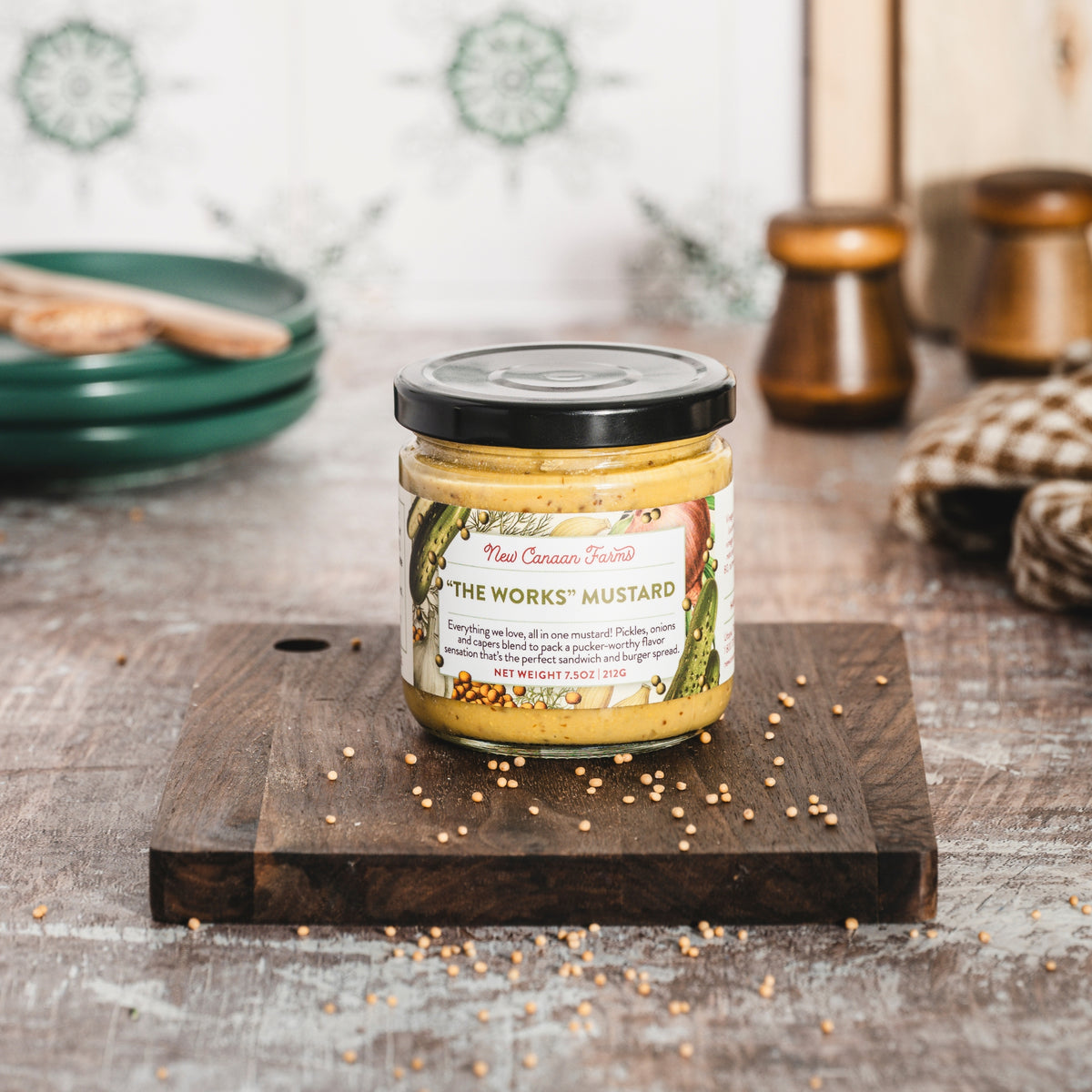 Jar of 'The Works' mustard on a wooden board with a rustic background