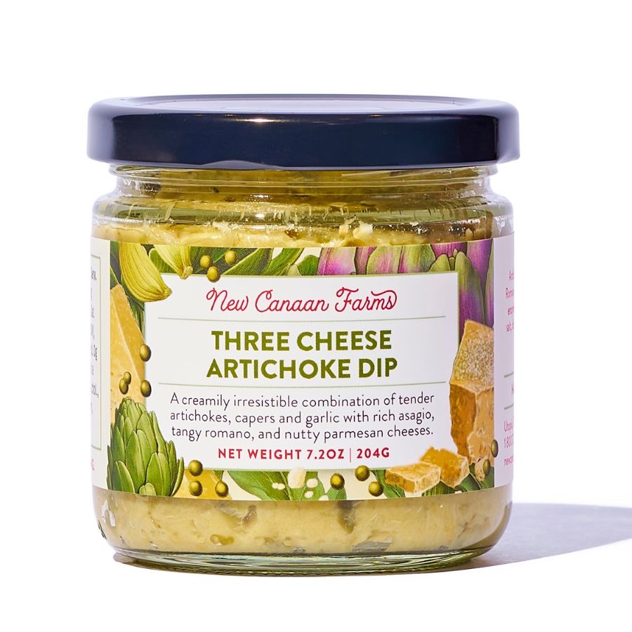 A jar of New Canaan Farms 3 Cheese Artichoke Dip with an artichoke and cheese illustrated label