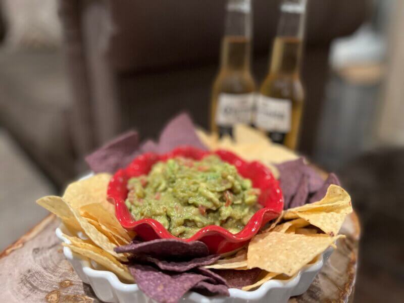 New Canaan Farms Verde Chili Salsa Guacamole, garnished with tortilla chips