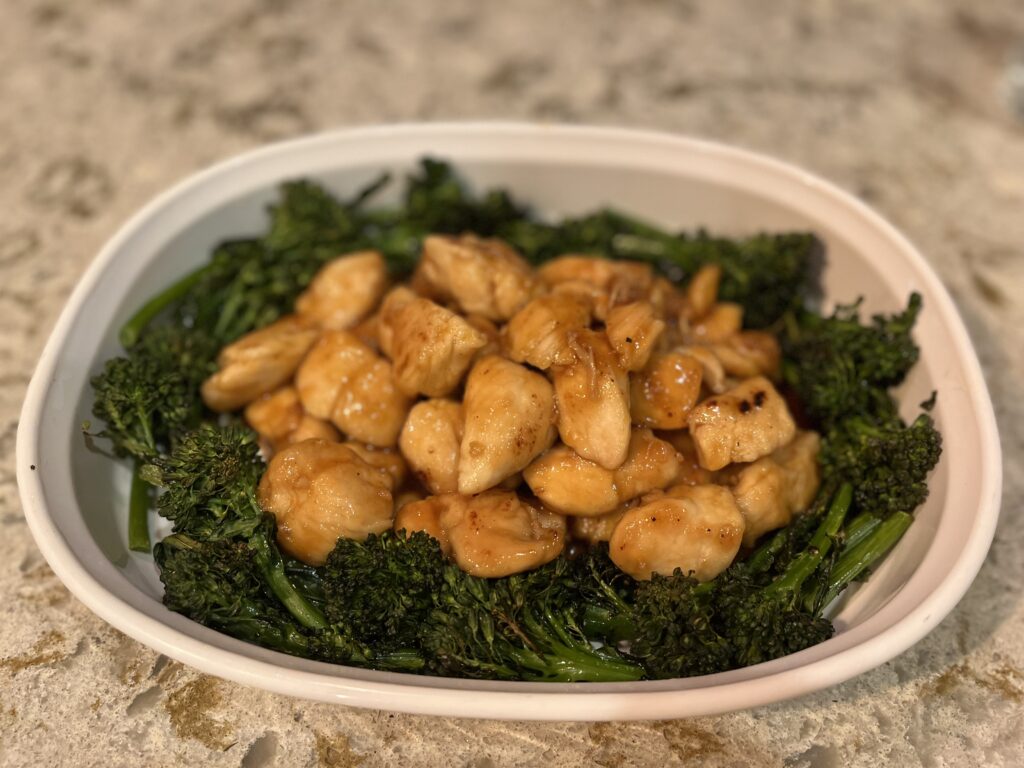 New Canaan Farms Apricot Chicken, served on a bed of roasted broccolini