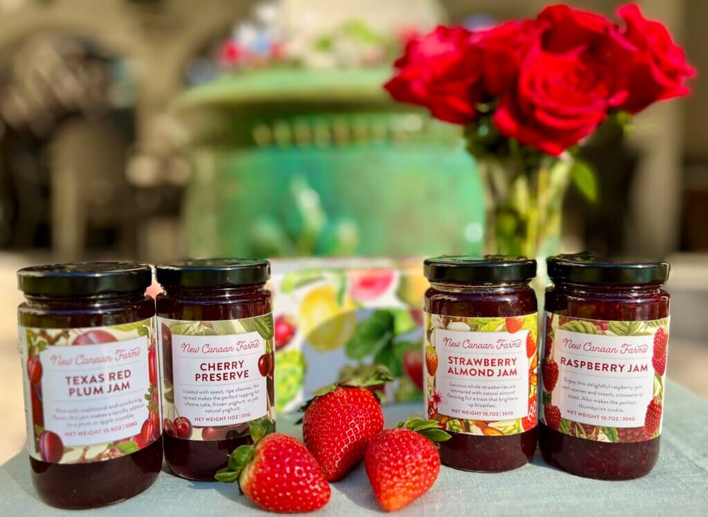 Four New Canaan Farms rich red jams with strawberries and a gift box