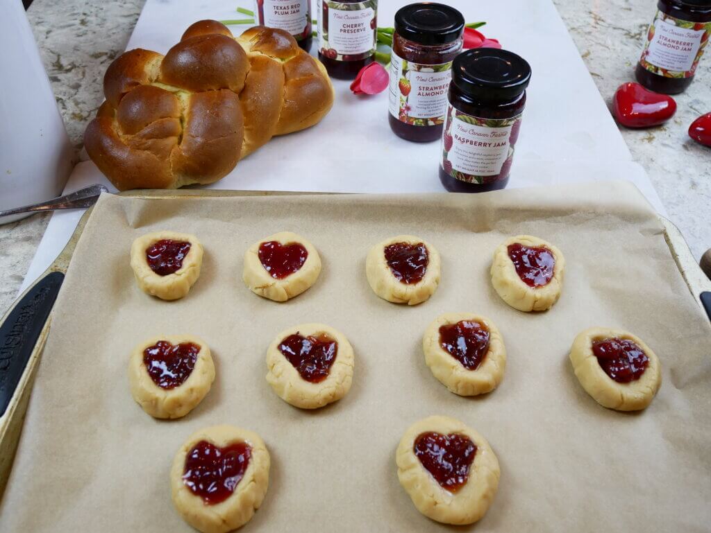 Thumbprint Valentine cookies filled with jam and ready for the oven