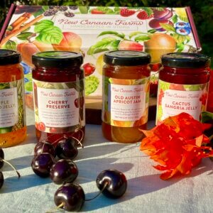 A collection of New Canaan Farms jams of fruit that ripens in Spring; Old Austin Apricot Jam, Cactus Sangria Jelly, Cherry Preserves and Pineapple Jalapeño Jelly