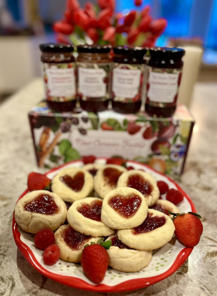 Valentine thumbprint cookies made with a variety of New Canaan Farms red fruit jams