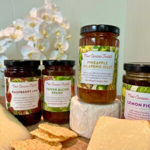 Collection of New Canaan Farms jams and relishes with a selection of cheeses