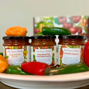 Three spicy New Canaan Farms salsas, Fire-Roasted Cantina, Habanero and the super hot Demon - surrounded with chilis