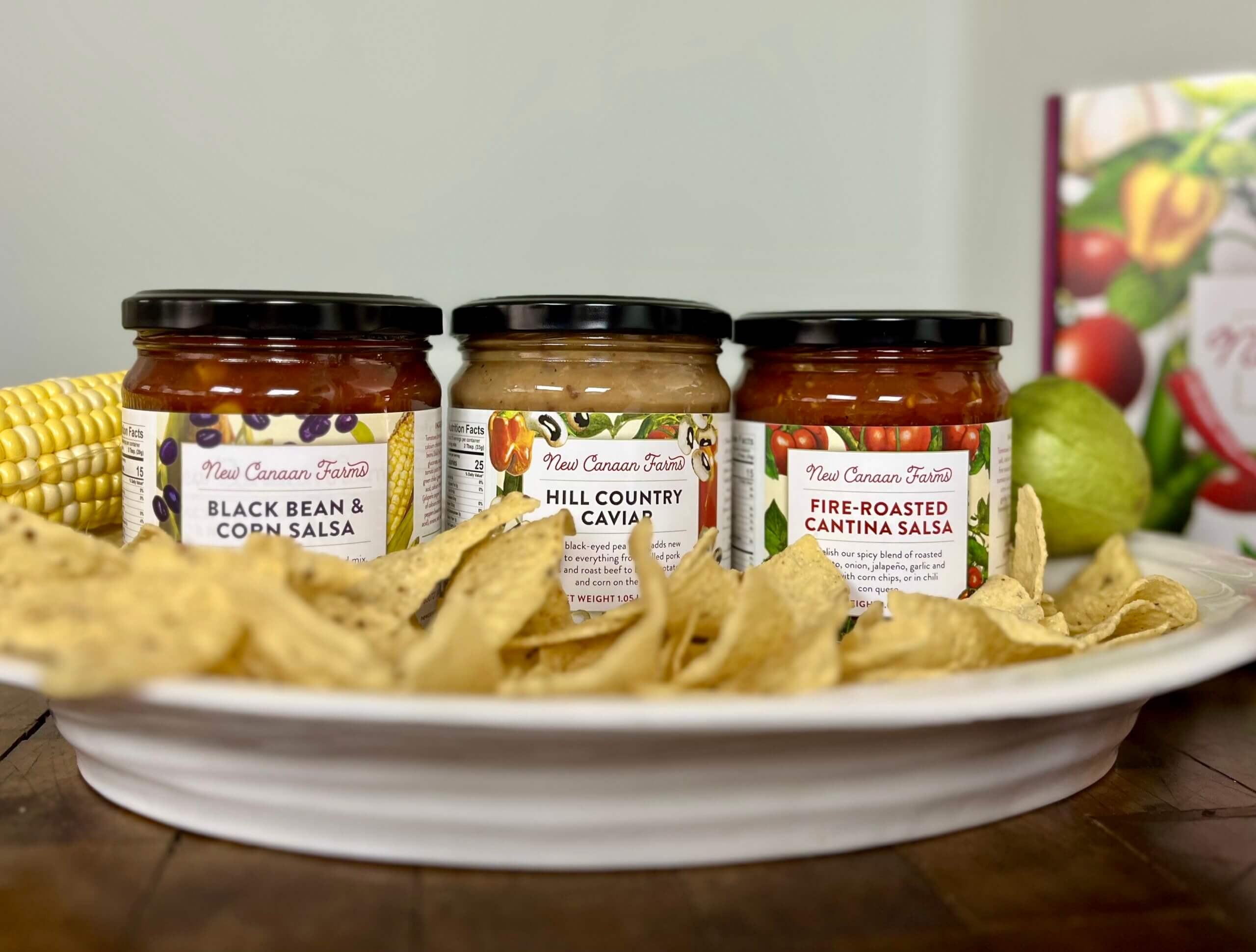 New Canaan Farms Black Bean & Corn, Hill Country and Fire-Roasted Cantina salsas, surrounded by tortilla chips