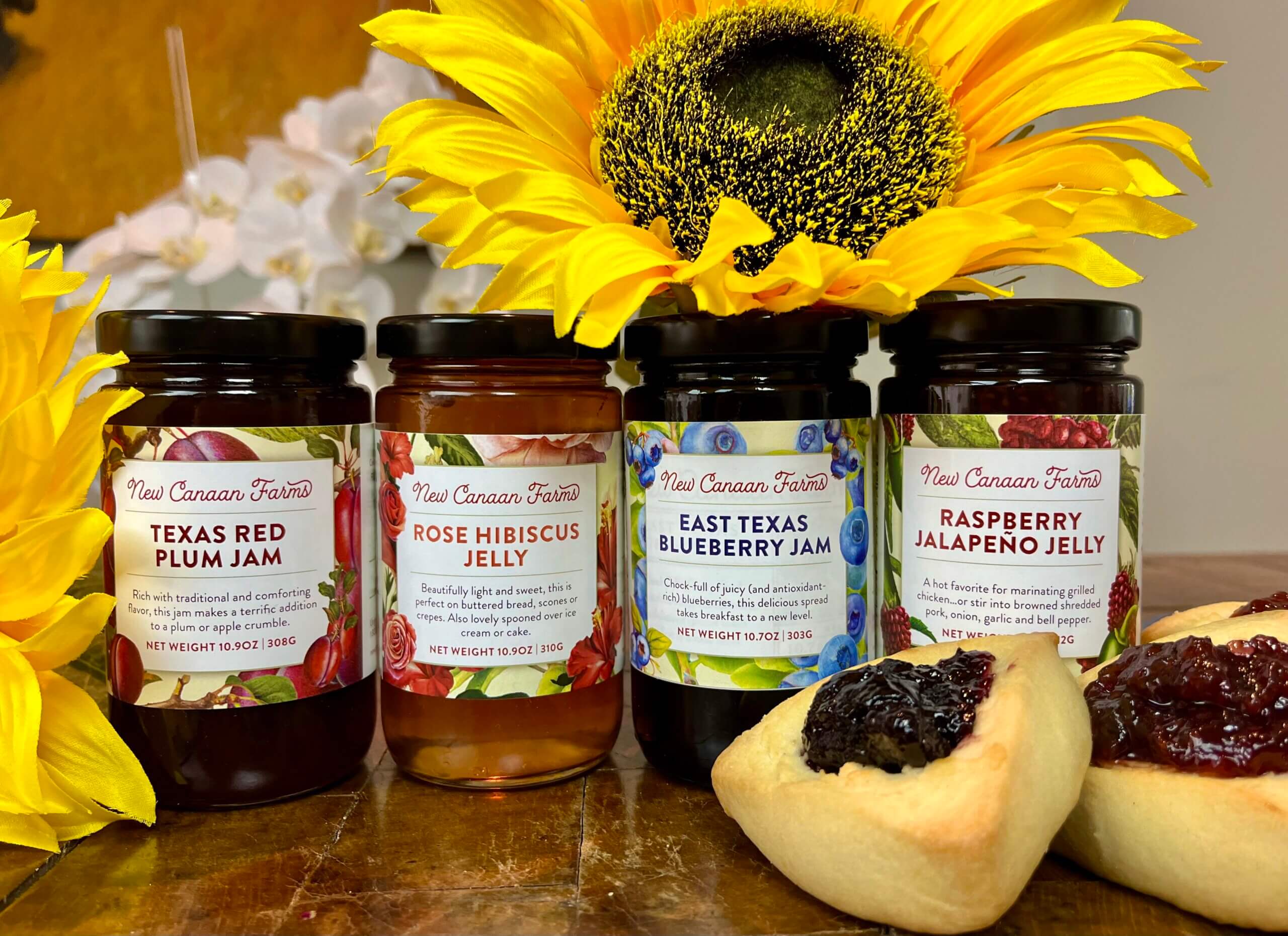 A collection of four New Canaan Farms summer-fruits jams; blueberry, raspberry jalapeño, rose hibiscus and red plum jams