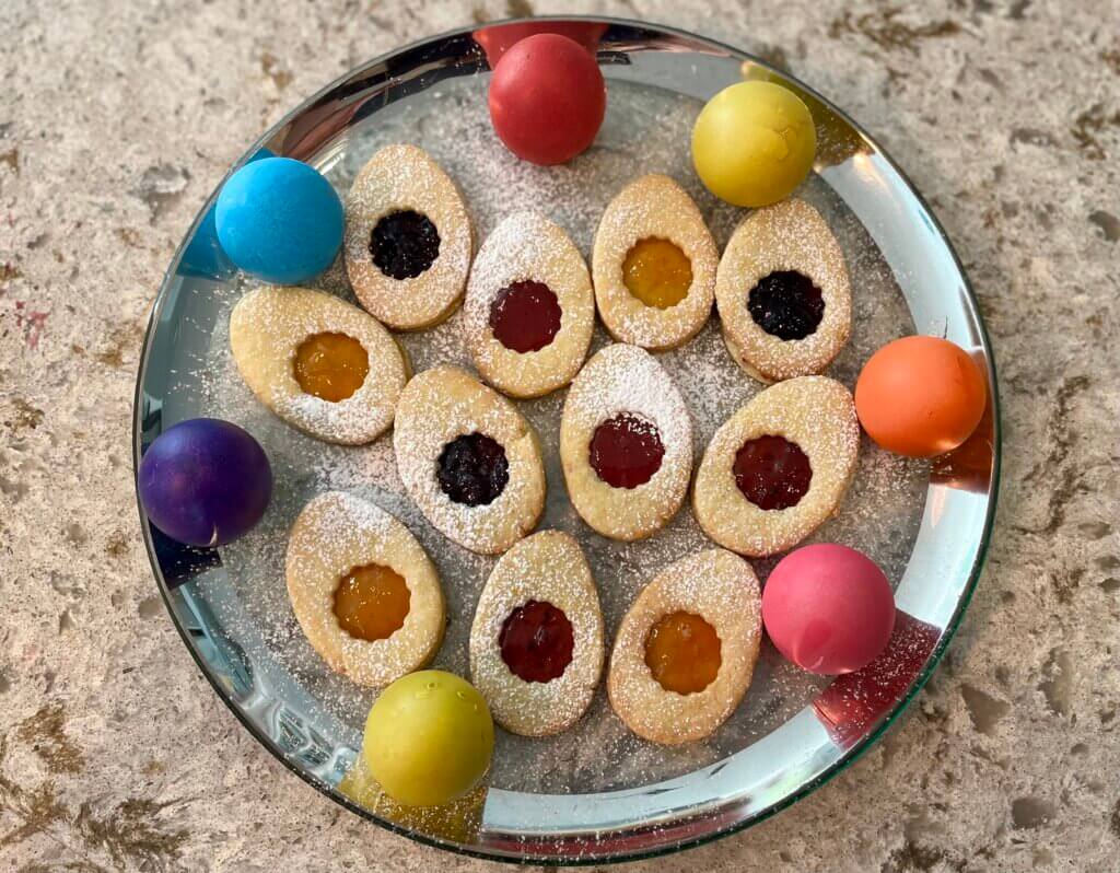 A plate of Easter egg jam cookies with cascarones