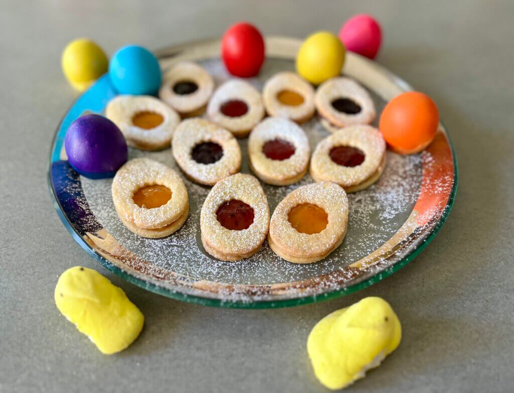 A platter of Easter egg jam cookies, with cascarones and Peeps