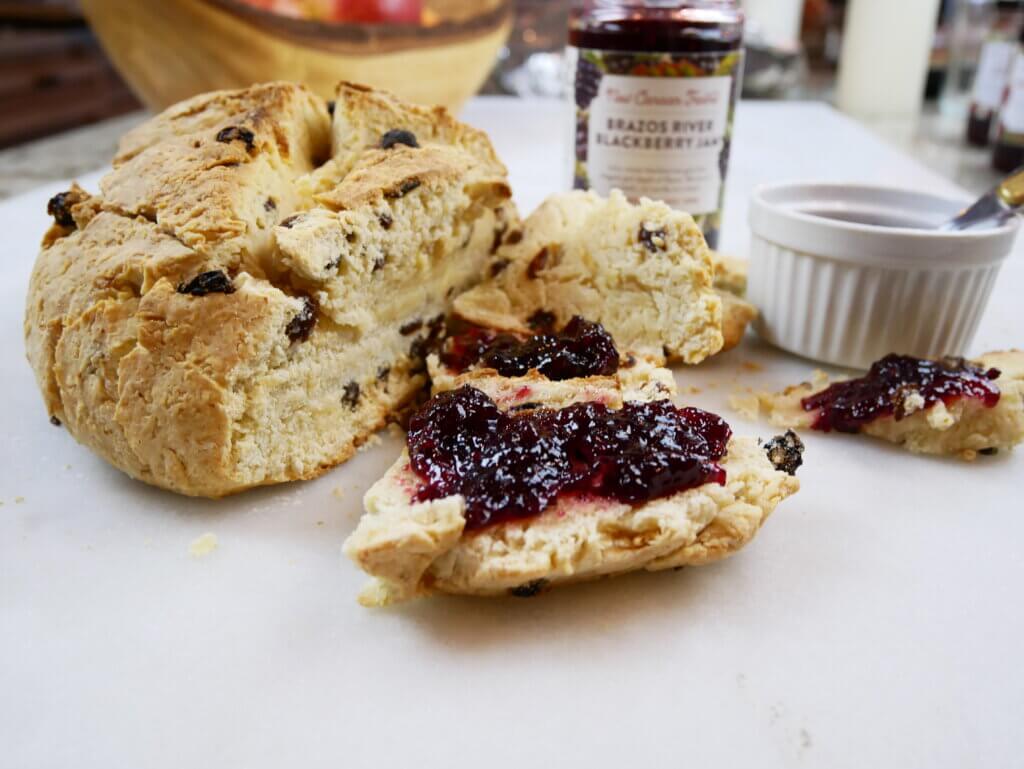 A loaf of sweet Irish soda bread with New Canaan Farms Brazos River Blackberry Jam