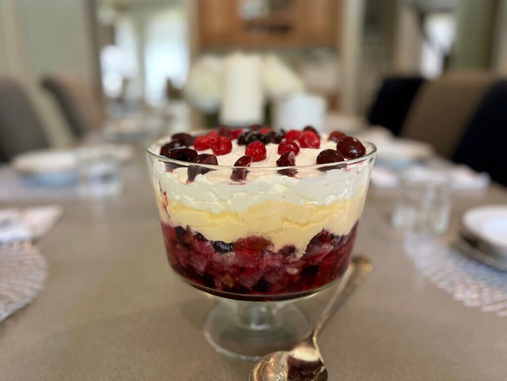 A large bowl of English trifle on a grey dining table