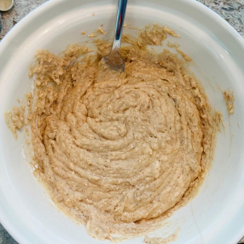 Apple muffin batter in a mixing bowl