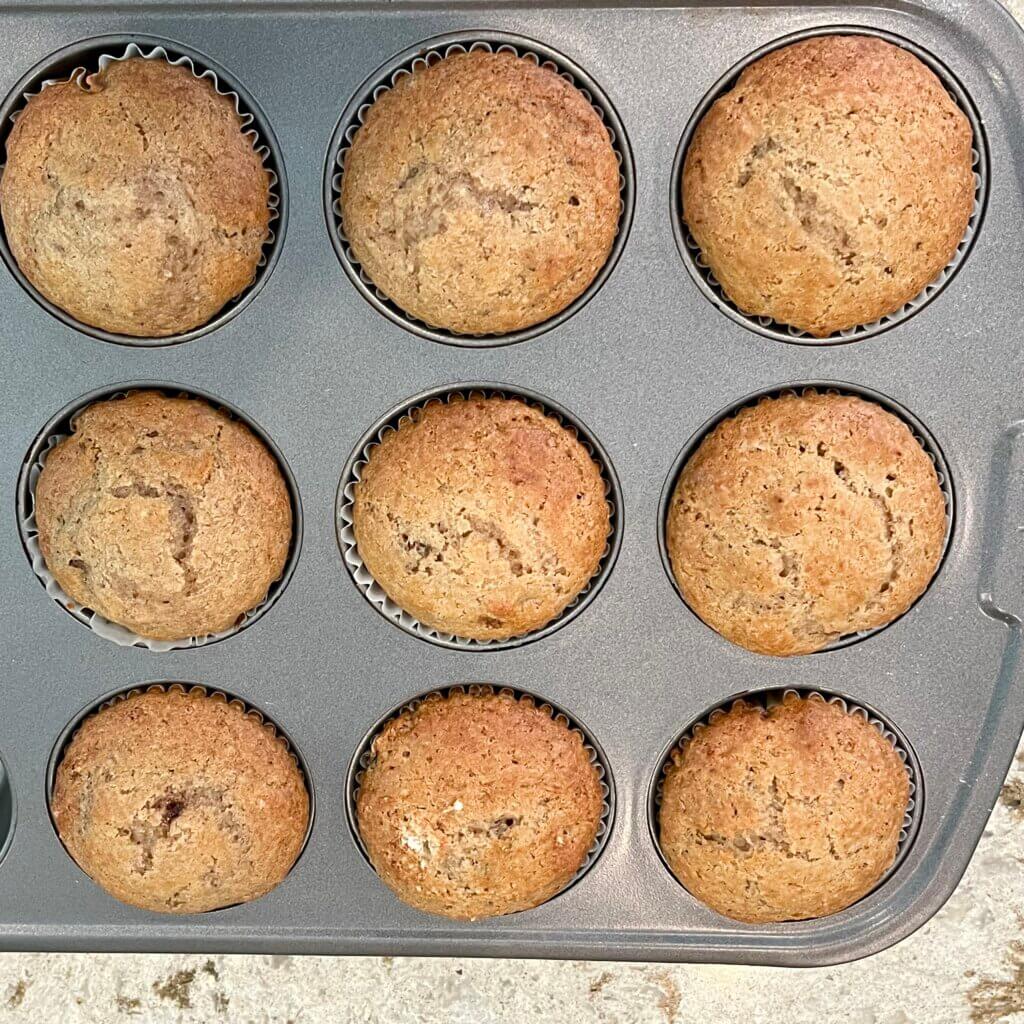 Cooked apple raisin muffins in their baking pan