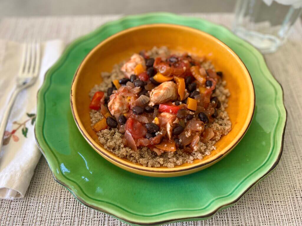 A bowl with healthy Mexican chicken casserole and quinoa