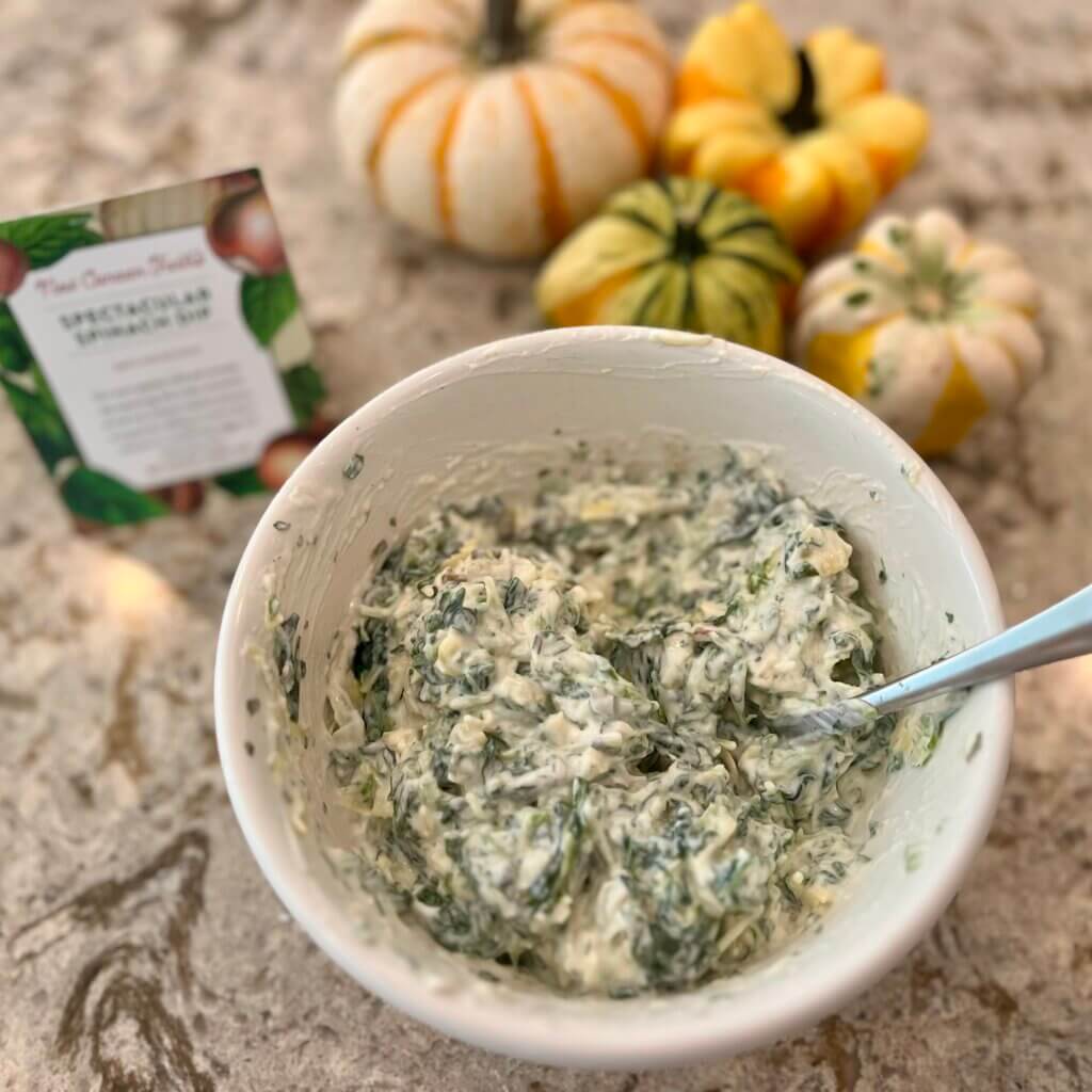 A bowl of spinach dip, made with New Canaan Farms Spectacular Spinach Dip