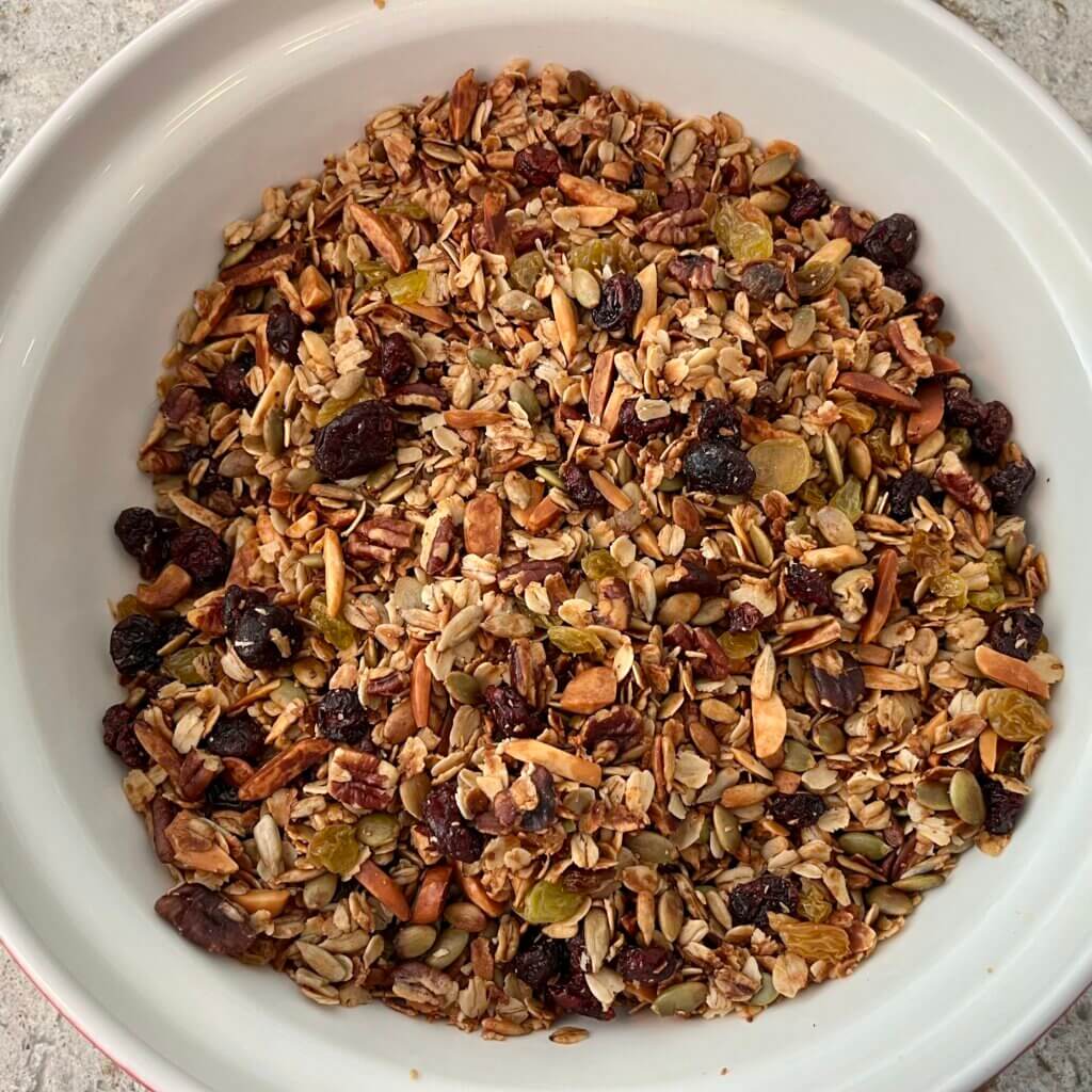 Cooked granola mixture in a large white bowl