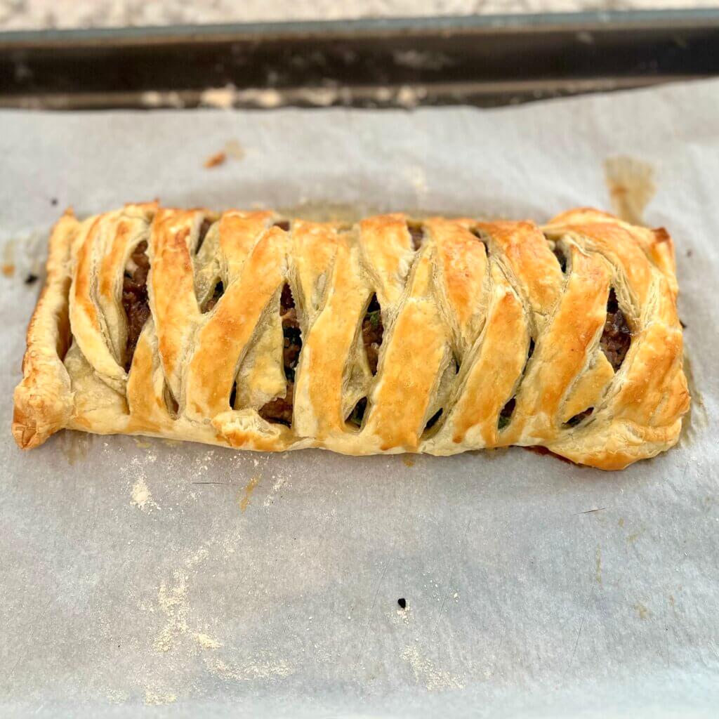 A large latticed sausage roll, fresh out of the oven