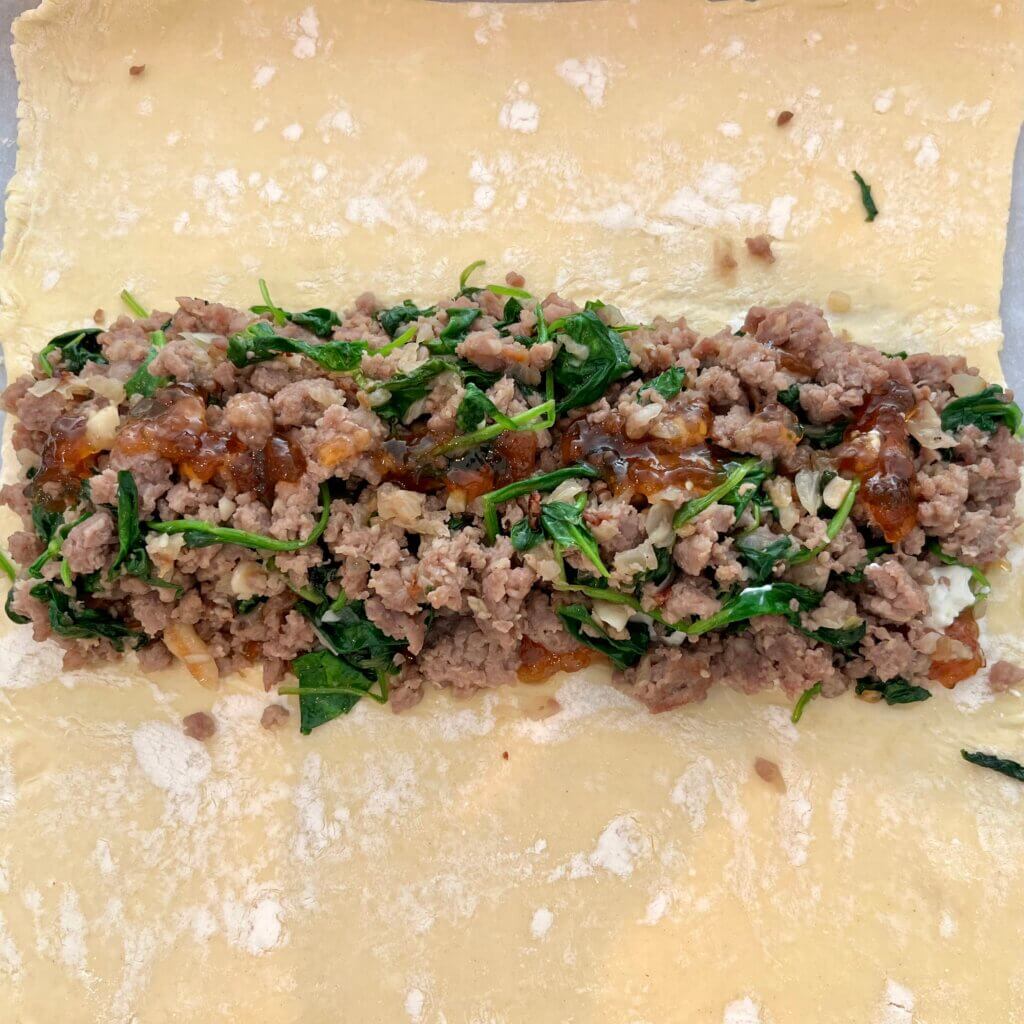 Sausage and spinach mixture, about to be wrapped into a puff pastry strudel