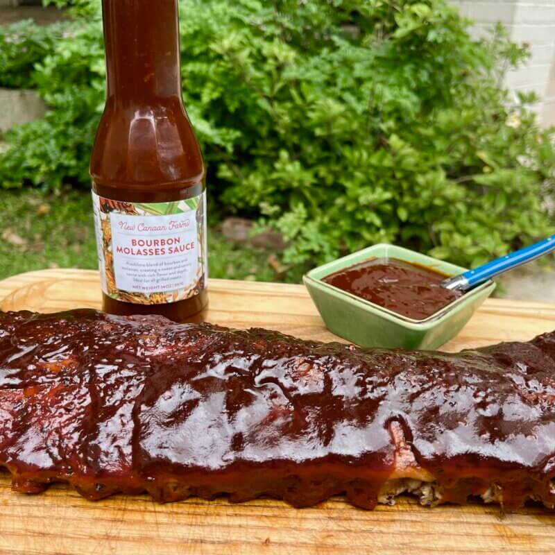 A rack of ribs cooked in New Canaan Farms Bourbon Molasses Sauce