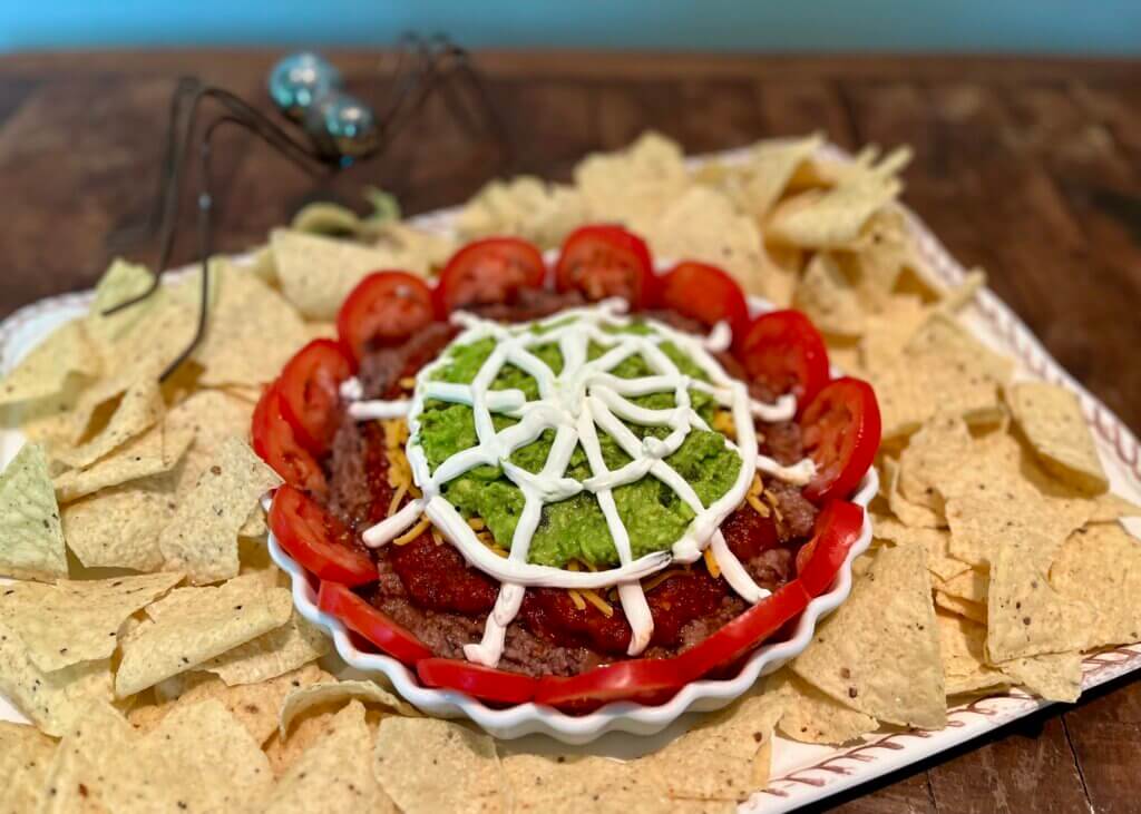 A spooky spidery 5-layer dip for Halloween, made with New Canaan Farms salsa