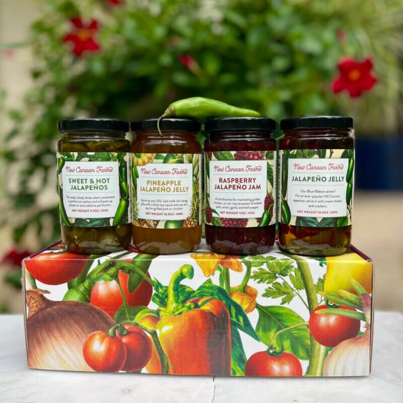 A New Canaan Farms jalapeño-themed gift box, containing Jalapeño Jelly, Pineapple Jalapeño Jelly, Raspberry Jalapeño Jam and Sweet & Hot Jalapeños