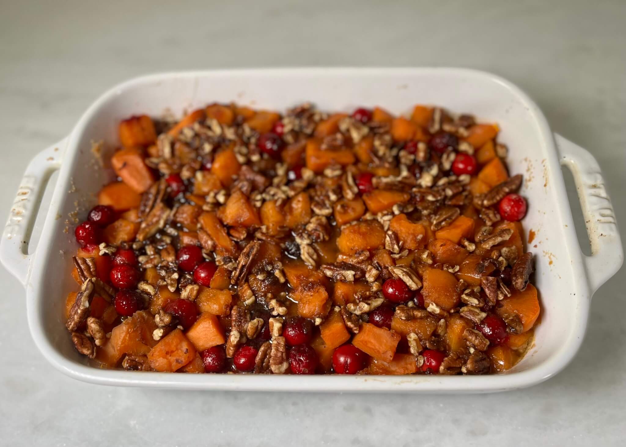 Sweet potato cranberry bake in a white casserole dish